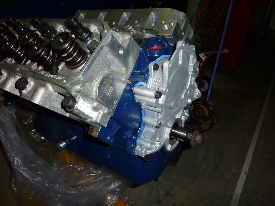 Engine block with blue paint and silver timing cover