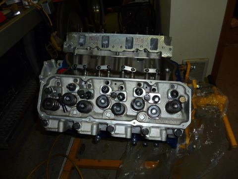 1971 Ford Mustang - Close-up view of engine cylinder heads, with visible valves and springs, on an engine stand.