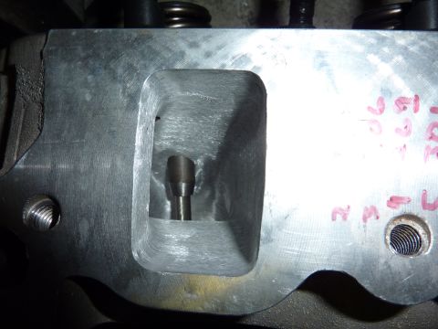 1971 Ford Mustang - A detailed view of an engine cylinder head, showing internal porting and a valve stem.