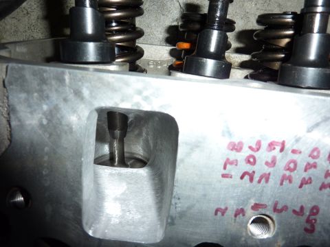 1971 Ford Mustang - Close-up of an engine cylinder head, showing valve train components and handwritten markings on the metal surface.
