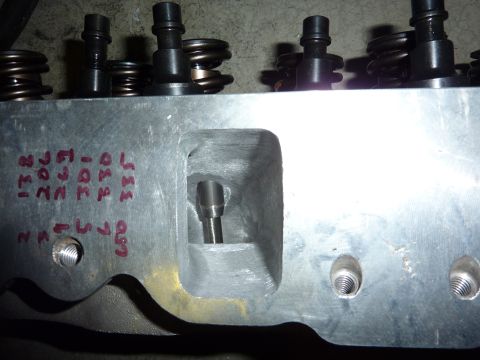 1971 Ford Mustang - Close-up of an engine cylinder head, showing valve springs, retainers, and handwritten markings.