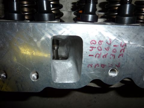 1971 Ford Mustang - Close-up of an engine cylinder head showing intake port and handwritten identification marks.