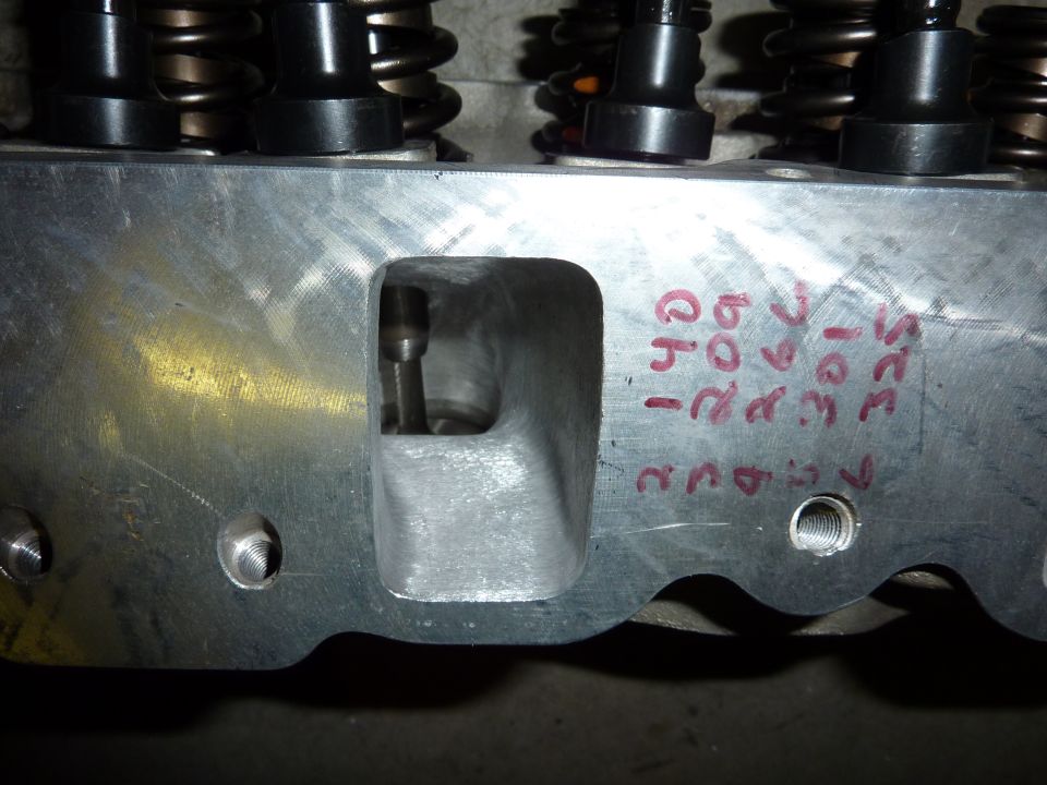 Aluminum engine cylinder head with intake port visible. Handwritten red markings include '351', '209', '140', '325', and 'ch'