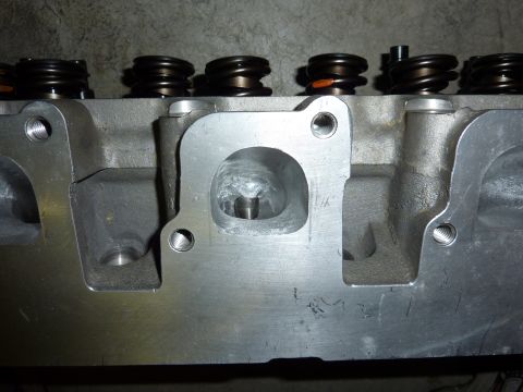 1971 Ford Mustang - A detailed view of a cylinder head, likely for a performance engine build, showing the intake port and valve springs.