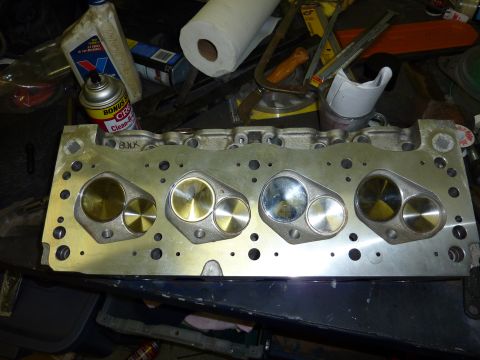 1971 Ford Mustang - A close-up view of an engine cylinder head, showing the valve openings and some handwritten text on the surface.