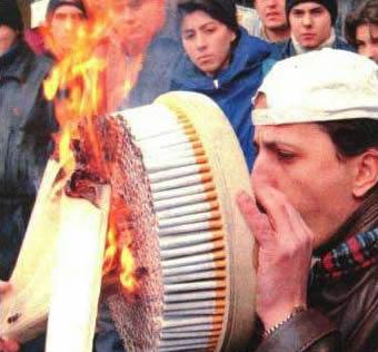 1996 Ford Bronco - A man reacts to a burning pack of cigarettes held by another person.