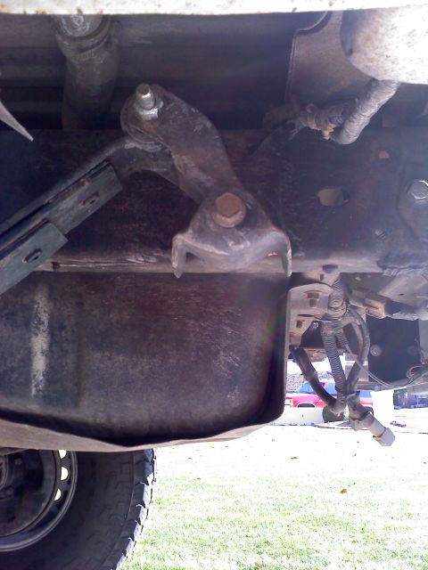 1996 Ford Bronco - Underside view of a vehicle's rear suspension component and associated wiring.