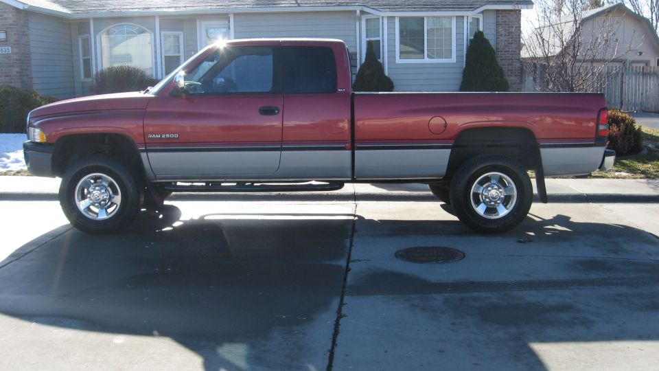 1997 Dodge 2500 pickup truck, side view, red and grey two-tone paint