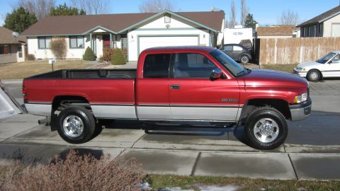 1997 Dodge 2500 - This Dodge pickup truck is parked on a residential street in front of a house.