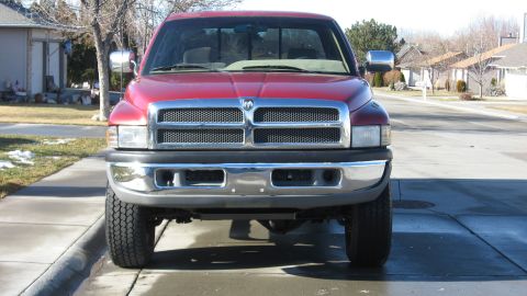 1997 Dodge 2500 - Front view of a red 1997 Dodge 2500 pickup truck parked on a residential street.