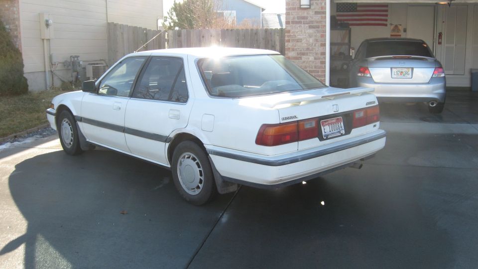 White 1989 Honda Accord sedan with a rear spoiler, parked in a driveway