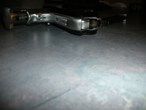 1996 Ford Bronco - A firearm is shown in a close-up view, highlighting its metallic components and construction.