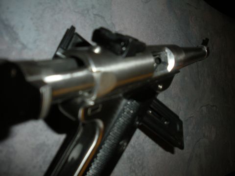 1996 Ford Bronco - Handgun with metallic finish and textured grip is shown in detail.