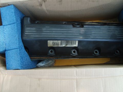 1993 Ford Crown Victoria - A black valve cover, likely a replacement part, is shown packed in a box with protective foam.