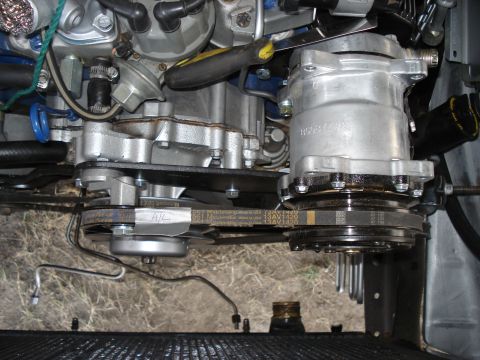 1979 Ford F-150 - The engine bay features an air conditioning compressor and drive belts, with visible text on one of the belts.