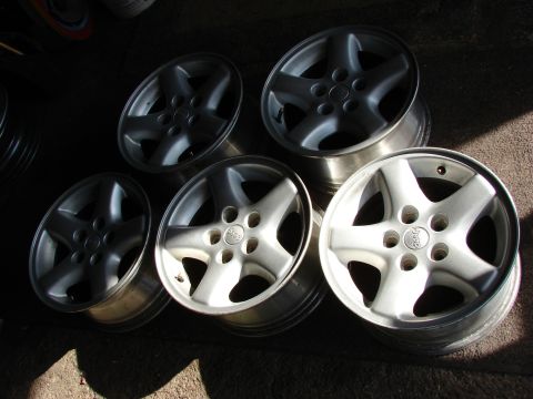 1996 Jeep Grand Cherokee - Five Jeep alloy wheels are shown, likely for a Grand Cherokee.