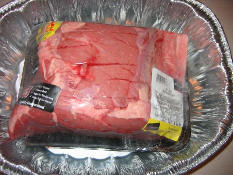 1992 Ford Bronco - A raw beef roast is packaged in plastic wrap and placed in a foil pan, with a USDA Choice label visible.