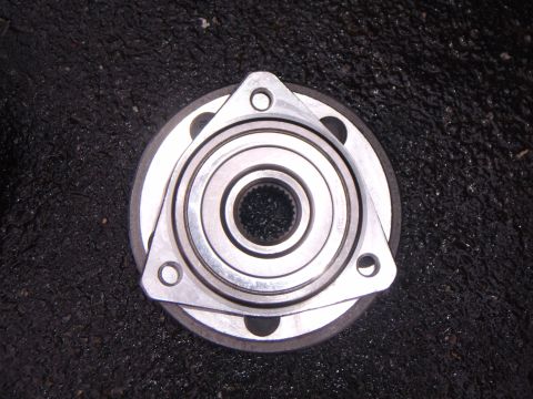 2003 Jeep Wrangler - A wheel hub bearing assembly is shown against a dark, textured surface.