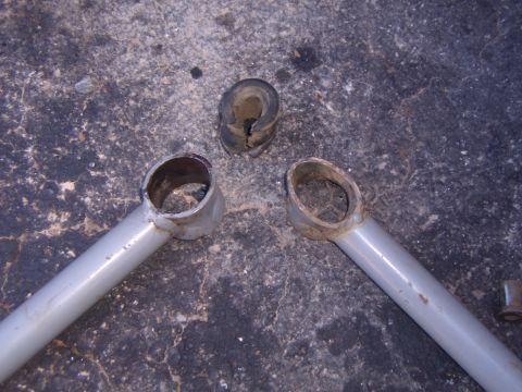 2003 Jeep Wrangler - Worn suspension bushings and control arms are shown on a concrete surface.