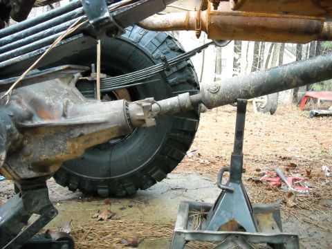 1979 Ford F-150 - The rear axle, leaf springs, and driveshaft of a 1979 Ford F-150 are visible while supported by jack stands.