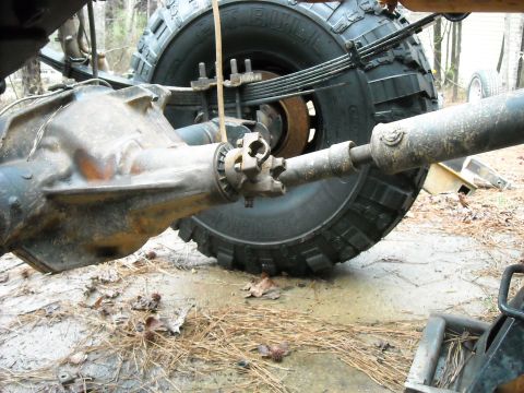1979 Ford F-150 - Close-up view of a vehicle's rear axle, driveshaft, and tire, showing mechanical components.