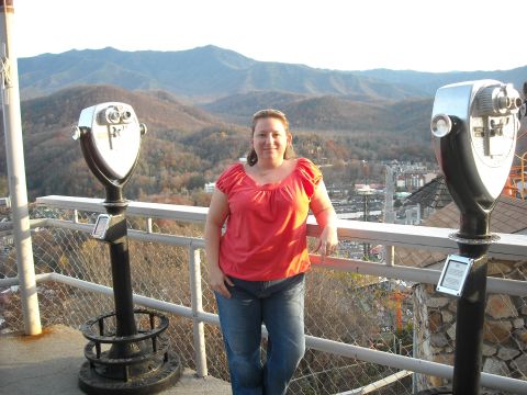 1979 Ford F-150 - Woman poses for a photo on an observation deck overlooking a town and mountains.