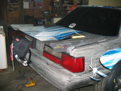 1992 Ford Mustang - Rear view of a customized 1992 Ford Mustang with a unique paint job and aftermarket spoiler.