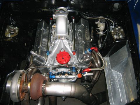 1992 Ford Mustang - A custom V8 engine with a turbocharger and intricate plumbing is visible in the engine bay.