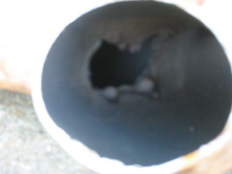 1995 Ford Bronco - Close-up view of the interior of an exhaust pipe, showing a large opening.