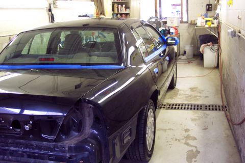 2001 Ford Crown Victoria - Black 2001 Ford Crown Victoria in a garage with the rear bumper removed.
