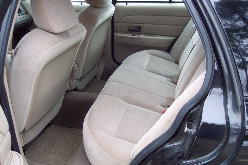 2001 Ford Crown Victoria rear interior with tan cloth seats and door panel