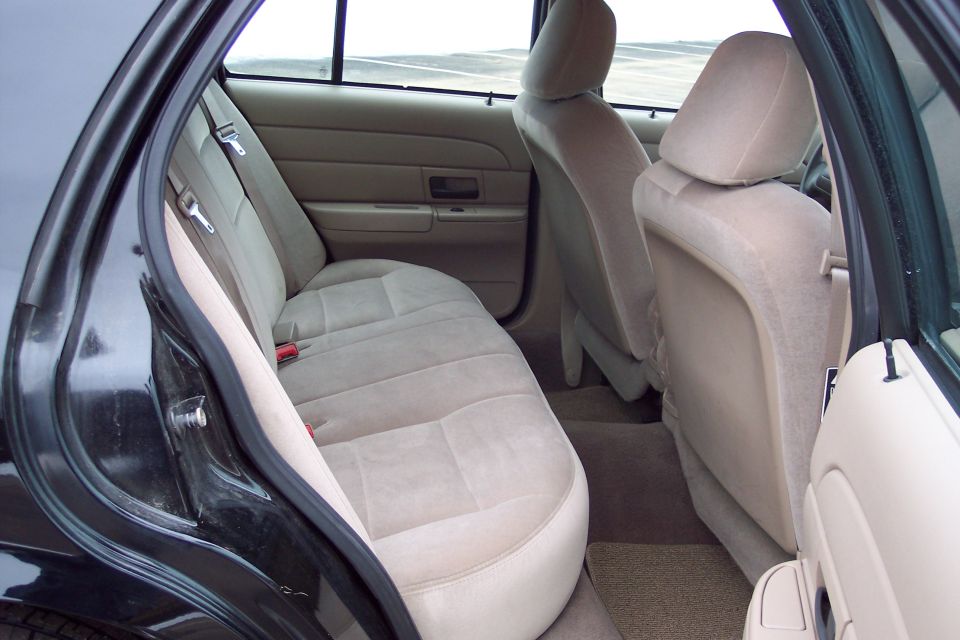 Interior rear seats of a 2001 Ford Crown Victoria, tan upholstery