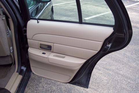 2001 Ford Crown Victoria - Interior view of a 2001 Ford Crown Victoria showing the tan door panel and black trim.