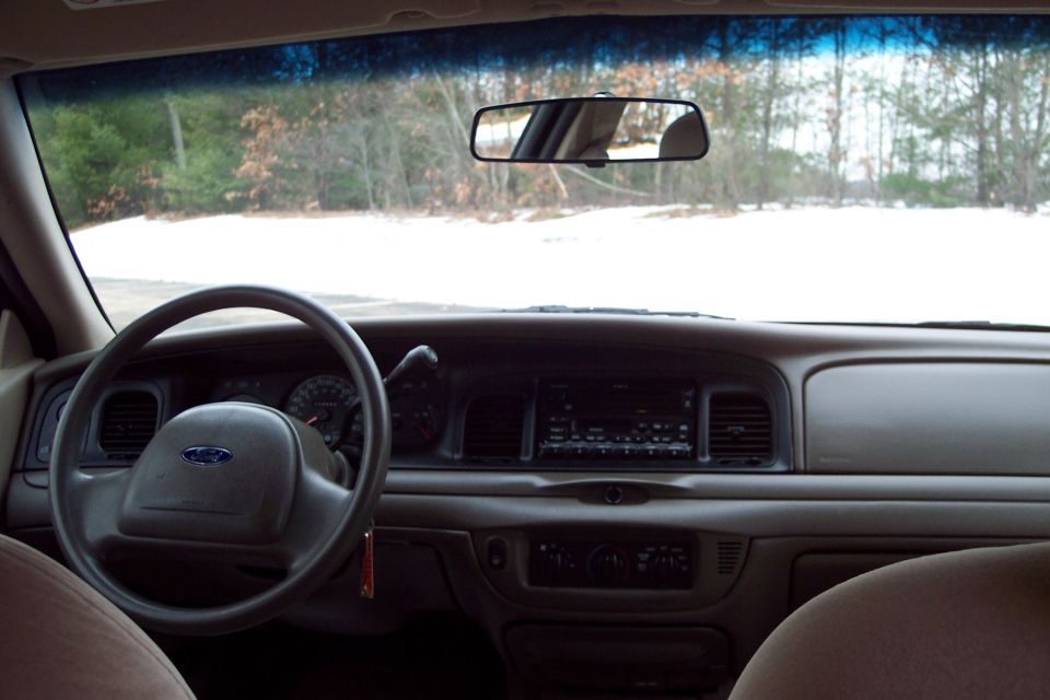 Interior view of a 2001 Ford Crown Victoria, showing the steering wheel and dashboard