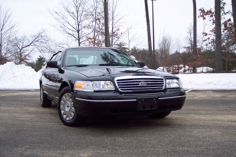 2001 Ford Crown Victoria - Front view of a black 2001 Ford Crown Victoria in a snowy outdoor setting.