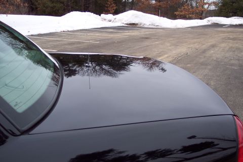 2001 Ford Crown Victoria - Rear view of a black 2001 Ford Crown Victoria parked in a snowy lot.