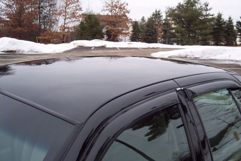 2001 Ford Crown Victoria - A black 2001 Ford Crown Victoria is shown from the side, focusing on the roof and window trim.