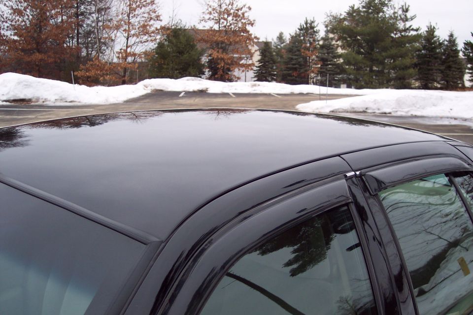 Black 2001 Ford Crown Victoria side view showing roof and window trim