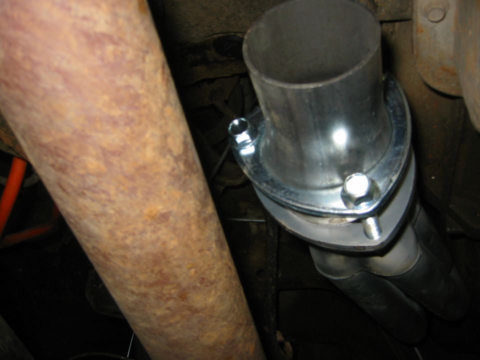 close-up of exhaust pipes being joined with a flange and bolts