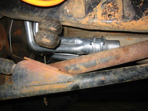 1995 Ford Bronco - Underside view of a vehicle's exhaust system and suspension components, showing rust and wear.