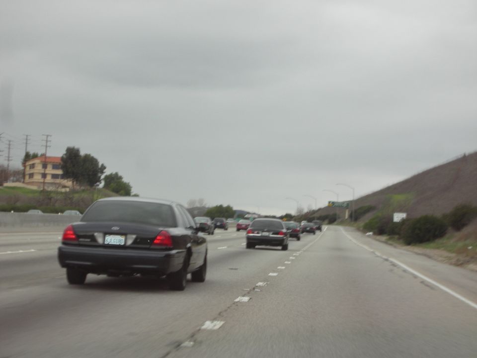 Black sedan from rear on highway, 1992 Ford Crown Victoria