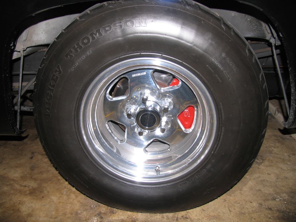Mickey Thompson Sportsman drag tire on polished five-spoke wheel under black fender