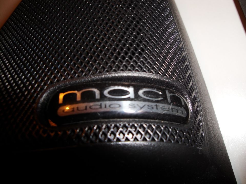 Black speaker grille with Mach audio system emblem