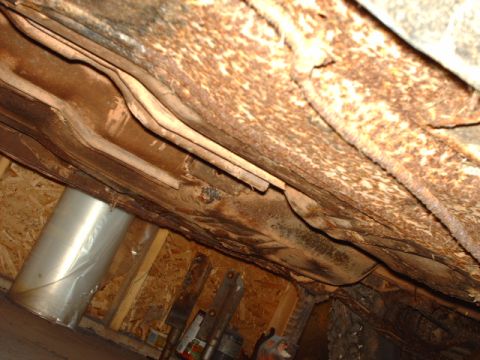 1978 Ford Mustang II - Undercarriage view reveals significant rust on frame rails and exhaust system components.