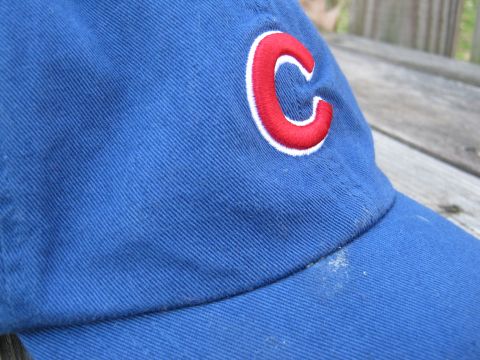 1988 Ford Bronco - A close-up of a blue baseball cap a red and white embroidered 'C' logo.