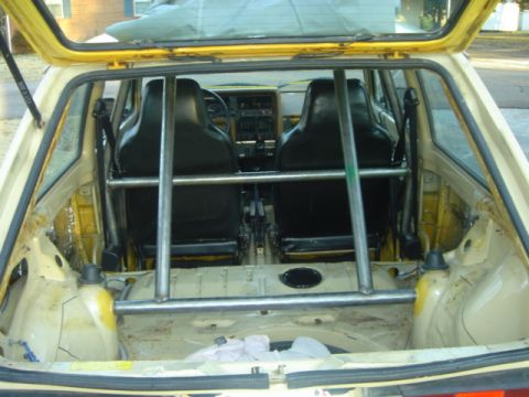 1983 Volkswagen Rabbit - Interior view of a 1983 Volkswagen Rabbit, modified with racing seats and a roll cage.