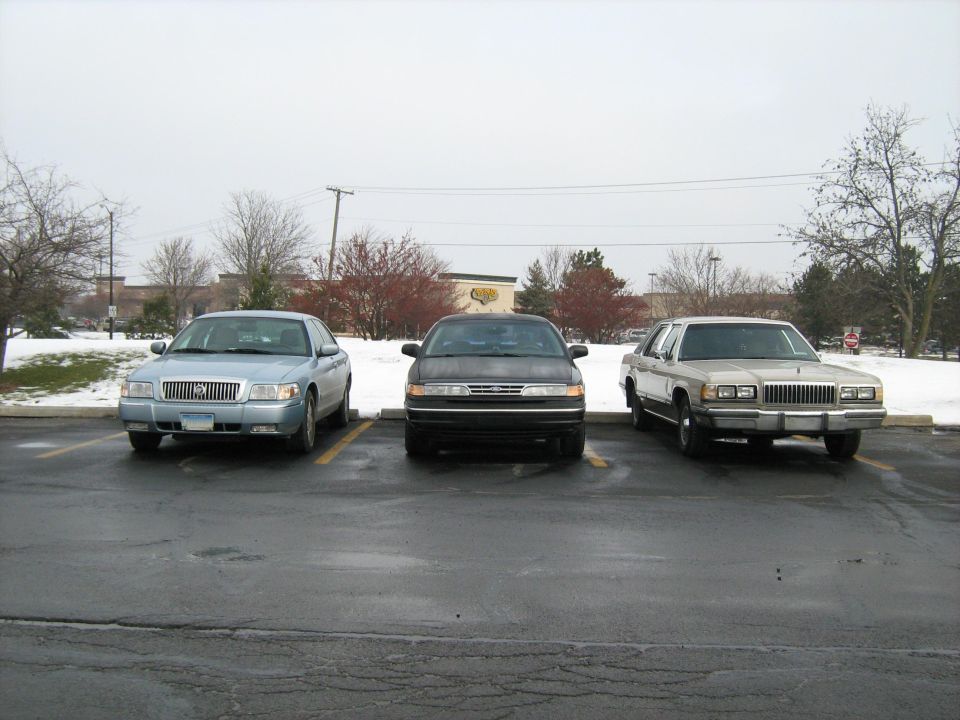 1988 Mercury Grand Marquis front view parked next to two other sedans