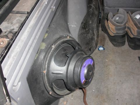 1994 Ford Bronco - Speaker installed in the interior of a vehicle, with boots in the background.