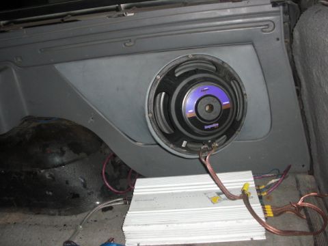 1994 Ford Bronco - Aftermarket audio equipment, including a subwoofer and amplifier, is installed in the rear of a vehicle.