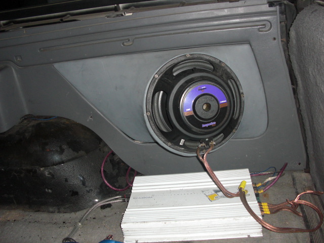 car amplifier and subwoofer installed in rear cargo area